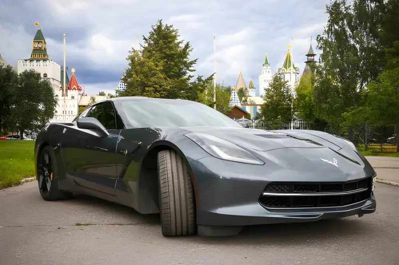 Chevrolet Corvette E-Ray hybrid sports car in red, front three-quarter view showing mid-engine design