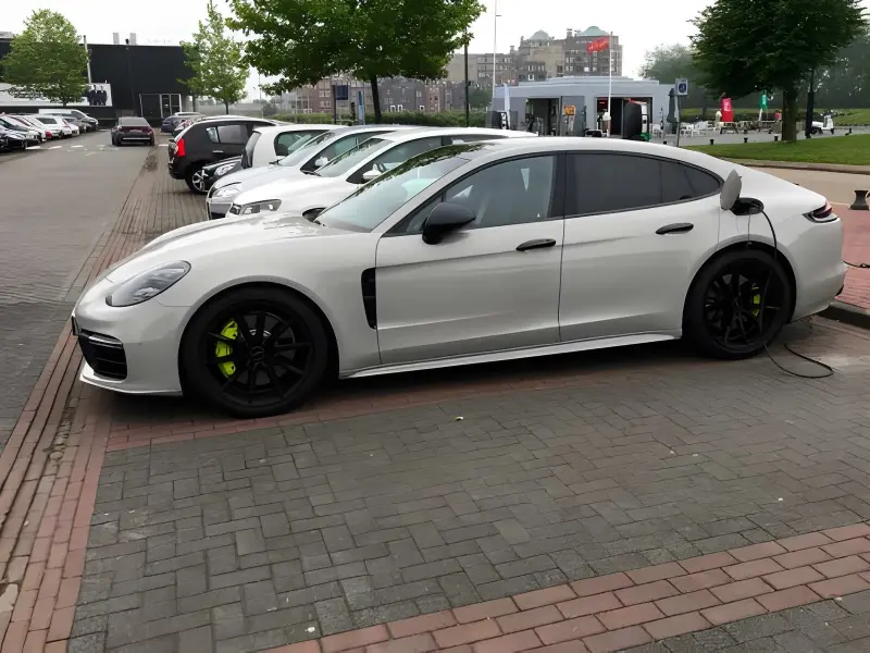Porsche Panamera Turbo S E-Hybrid in black, front three-quarter view showing four-door grand tourer proportions
