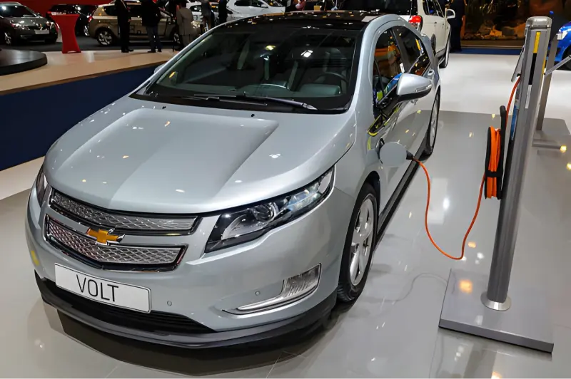 Chevy EV home charger mounted on a garage wall next to a Chevrolet Equinox EV